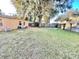 Large grassy backyard with a wooden fence at 770 Carver St, Winter Park, FL 32789