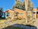 Tan single-story house with a walkway and palm tree at 770 Carver St, Winter Park, FL 32789