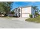 Two-story house with a two-car garage and mature trees at 8102 Settlers Creek Cir, Lakeland, FL 33810