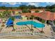 Community pool with lounge chairs and umbrellas at 1005 Park Ridge Cir, Kissimmee, FL 34746