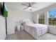 Bedroom with a queen bed, TV, and large windows at 11006 Silver Surfer Aly, Winter Garden, FL 34787