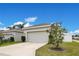 Single car garage with light-colored door and landscaping at 11006 Silver Surfer Aly, Winter Garden, FL 34787