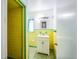 Retro style bathroom with yellow tile and white vanity at 120 Sunset Blvd, Polk City, FL 33868