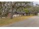 House exterior showcasing a long driveway and oak trees at 120 Sunset Blvd, Polk City, FL 33868