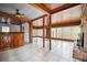 Spacious living room with wood paneling, fireplace, and tile floors at 120 Sunset Blvd, Polk City, FL 33868