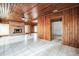 Living area with wood walls, fireplace, and tile flooring at 120 Sunset Blvd, Polk City, FL 33868