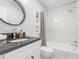 Modern bathroom with white subway tile, soaking tub, and dark vanity at 123 N Hyer Ave, Orlando, FL 32801