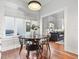 Bright dining room with a round wooden table and four black chairs at 123 N Hyer Ave, Orlando, FL 32801