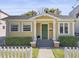 Yellow bungalow with green door and white picket fence at 123 N Hyer Ave, Orlando, FL 32801