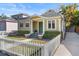 Craftsman style bungalow with green door, white picket fence, and manicured lawn at 123 N Hyer Ave, Orlando, FL 32801