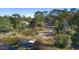 Aerial view showcasing a property with a lake, dock, and surrounding woodland at 1260 Lake Helen Osteen Rd, Lake Helen, FL 32744