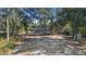 Aerial view of a house nestled among the trees on a spacious lot at 1260 Lake Helen Osteen Rd, Lake Helen, FL 32744