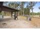 Covered patio, grill, fenced yard with playset at 1260 Lake Helen Osteen Rd, Lake Helen, FL 32744