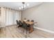 Bright dining room with wood table and four chairs, hardwood floors at 1260 Lake Helen Osteen Rd, Lake Helen, FL 32744