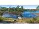 Tranquil lakefront view with a dock and small boat at 1260 Lake Helen Osteen Rd, Lake Helen, FL 32744