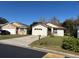 Two houses, one tan and one white, with attached garages at 138 Meadow Blvd, Sanford, FL 32771