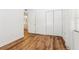 Bedroom with wood-look floors and access to a bathroom at 1413 Evangeline Ave, Orlando, FL 32809