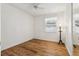 Simple bedroom with wood flooring, ceiling fan and a window at 1413 Evangeline Ave, Orlando, FL 32809