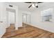 Bright bedroom featuring wood-look floors and mirrored closet at 1413 Evangeline Ave, Orlando, FL 32809