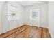 Spacious bedroom with wood-look floors and two windows at 1413 Evangeline Ave, Orlando, FL 32809