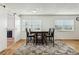 Dining area with wood floors, barn door, and dark wood table at 1413 Evangeline Ave, Orlando, FL 32809