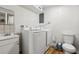 Laundry room with washer, dryer, toilet and sink at 1413 Evangeline Ave, Orlando, FL 32809