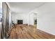 Bright living room featuring wood-look floors and a brick fireplace at 1413 Evangeline Ave, Orlando, FL 32809