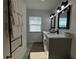 Modern bathroom with double vanity, grey cabinets, and large mirrors at 1490 11Th Ave, Deland, FL 32724