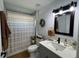 Bathroom featuring a granite vanity, dark fixtures, patterned shower curtain, and a toilet at 1490 11Th Ave, Deland, FL 32724