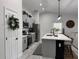 Kitchen featuring gray cabinetry, an island with pendant lighting, and stainless steel appliances at 1490 11Th Ave, Deland, FL 32724