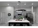 Spacious kitchen displays a central island with a light countertop, complemented by gray cabinetry and contemporary pendant lighting at 1490 11Th Ave, Deland, FL 32724