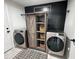 Laundry room with side-by-side washer and dryer and a decorative black accent wall with shelving at 1490 11Th Ave, Deland, FL 32724