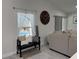 Bright living room features stylish bench seating, natural light, and decorative elements, creating a cozy atmosphere at 1490 11Th Ave, Deland, FL 32724