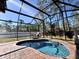 Relaxing screened pool area with brick surround, chaise lounge, and lush landscaping, perfect for leisure at 1490 11Th Ave, Deland, FL 32724