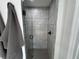 Modern walk-in shower features updated fixtures, glass door, and neutral tiles, creating a clean aesthetic at 1490 11Th Ave, Deland, FL 32724