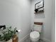 Cozy toilet room featuring a decorative shelf, soft textures, and plenty of natural light at 1490 11Th Ave, Deland, FL 32724