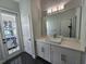 Clean bathroom with modern vanity and access to backyard at 15783 Tangerine Dream Ct, Winter Garden, FL 34787