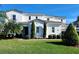 Stunning two-story home with modern design, manicured lawn, and palm trees at 15783 Tangerine Dream Ct, Winter Garden, FL 34787