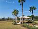 Park pavilion with benches, landscaping, and palm trees, overlooking a lake at 15783 Tangerine Dream Ct, Winter Garden, FL 34787