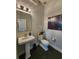 Powder room with pedestal sink and dark floors at 15783 Tangerine Dream Ct, Winter Garden, FL 34787