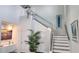 Modern staircase with glass railings and unique art piece at 15783 Tangerine Dream Ct, Winter Garden, FL 34787