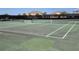 Outdoor tennis court with green surface and net, ready for a match at 15783 Tangerine Dream Ct, Winter Garden, FL 34787