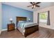 Bedroom with ceiling fan, wood-toned furniture, and light blue walls at 1715 Concert Rd, Deltona, FL 32738