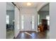 Bright and airy entryway with hardwood floors and barn door at 1715 Concert Rd, Deltona, FL 32738