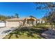 Charming single-story home with a well-manicured lawn, two-car garage, and covered front porch at 1715 Concert Rd, Deltona, FL 32738