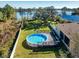 Round above ground pool with a wooden deck overlooking the lake at 1715 Concert Rd, Deltona, FL 32738