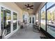 Relaxing screened porch with patio furniture and ceiling fan at 1715 Concert Rd, Deltona, FL 32738