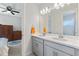 Bathroom boasts a double vanity with gray cabinets and a modern design at 1861 Goblet Cove St, Kissimmee, FL 34746