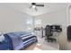 Bedroom with built-in desk, ceiling fan, and striped bedding at 1861 Goblet Cove St, Kissimmee, FL 34746