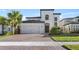 Two-story house with a two car garage and landscaped yard at 1861 Goblet Cove St, Kissimmee, FL 34746